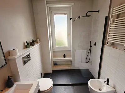 a bathroom with a shower and a toilet and a sink at Quarto Piano - intero alloggio a Roma in Rome