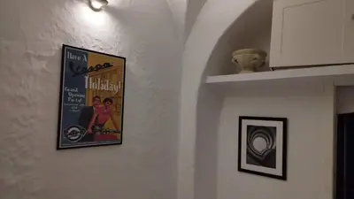 a movie poster on a wall in a room at Casa Bertani in Rome