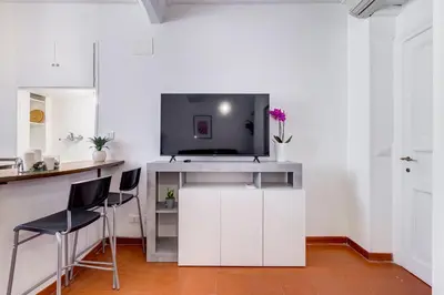 a kitchen with a tv on top of a white counter at Pigna suite in Rome