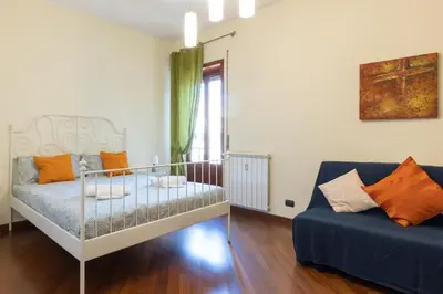 a small room with a crib and a couch at 2 Vatican St Peter's Daniele apartment Barone in Rome