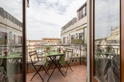 a balcony with a table and chairs on a balcony at 2 Vatican St Peter's Daniele apartment Barone in Rome