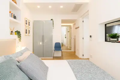 a bedroom with a bed and a blue chair at Modern & Elegant by NDP rent in Rome