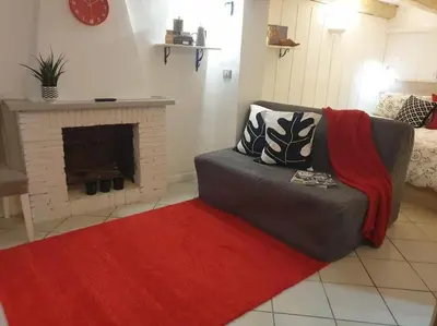 a living room with a couch and a fireplace at Al moretto in Rome