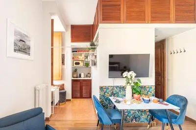a living room with a table and blue chairs at 4 Townhouse by the Spanish Steps in Rome