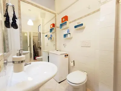 a white bathroom with a sink and a toilet at LAVINIA VATICAN HOME in Rome