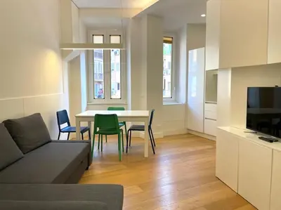 a living room with a couch and a table and chairs at Il Nido Apartment in Rome