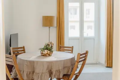 a dining room table with a vase of flowers on it at Valentine's Dream in Rome