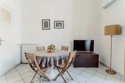 a dining room with a table and chairs and a tv at Valentine's Dream in Rome