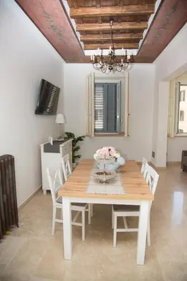 a dining room with a wooden table and chairs at Casa vacanza Colosseo 2 in Rome