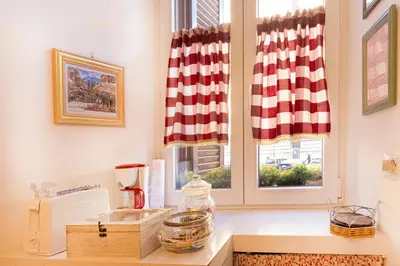 a kitchen with a counter with a window at La Casa di Vittorio boutique Ottaviano San Pietro in Rome