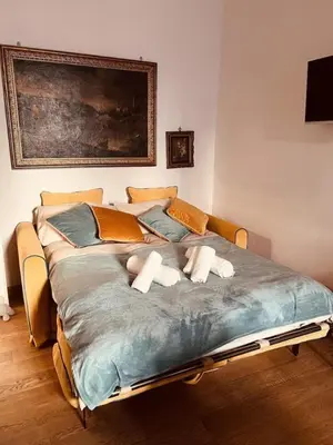 a large bed with two pillows on top of it at La Casa di Vittorio boutique Ottaviano San Pietro in Rome