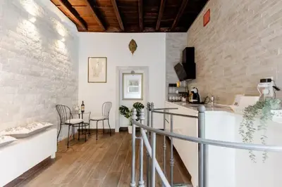 a kitchen with a counter and a table with chairs at Trastevere's Nest in Rome