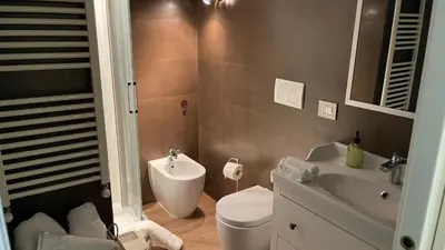 a bathroom with a toilet and a sink at Frank Host Roma Lux , Metro A a 50 m, simple check-in con codice a qualsiasi orario in Rome