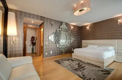 a bedroom with a bed and a couch in it at Penthouse Suite Rome - Private Suites in Rome