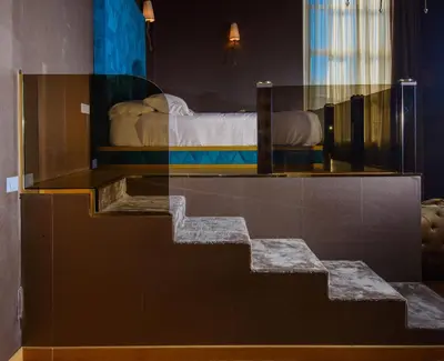 a glass staircase in a room with a bed at Penthouse Suite Rome - Private Suites in Rome