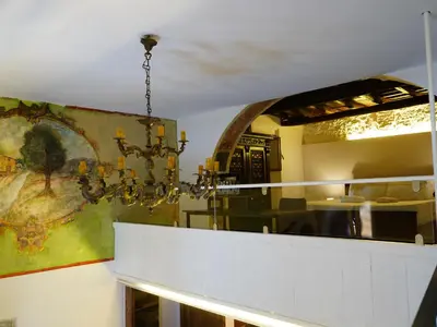 a chandelier hanging over a counter in a restaurant at Tre Colonne in Rome
