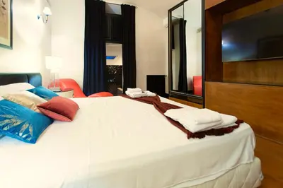 a bedroom with a large white bed with pillows on it at Cloe Suite - A due passi da Villa Borghese in Rome