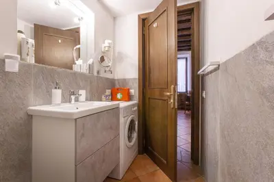 a bathroom with a sink and a washing machine at Happy Trastevere in Rome in Rome