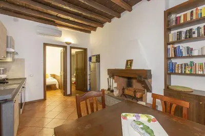 a kitchen and dining room with a table and a fireplace at Happy Trastevere in Rome in Rome
