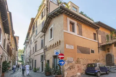 a group of people walking down a street next to buildings at Happy Trastevere in Rome in Rome