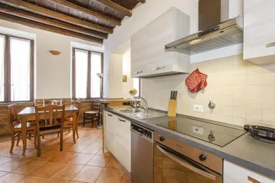 a kitchen with a table and a dining room at Happy Trastevere in Rome in Rome