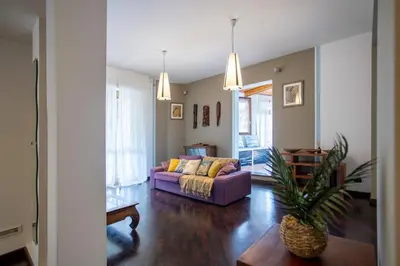 a living room with a purple couch and a table at Aurelia - Roof Garden close to Vatican in Rome