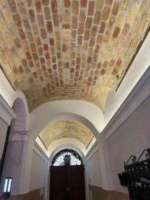 a building with a stone ceiling with a window at Natale del Grande flat in Rome