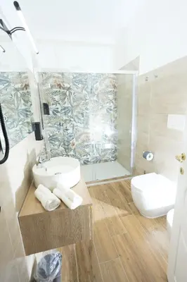 a bathroom with a sink and a shower and a toilet at Sant'Erasmo Rooms in Rome