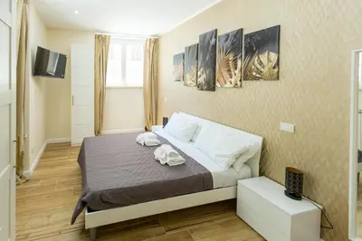 a bedroom with a bed with two towels on it at Sant'Erasmo Rooms in Rome