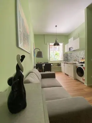 a living room with a couch and a kitchen at Carpegna42 in Rome