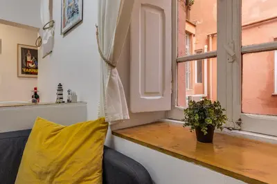 a yellow pillow sitting on a window sill at Gladiator's House in Rome