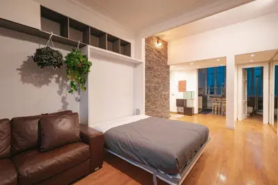 a living room with a couch and a flat screen tv at Rdr Tortona Rooms in Rome