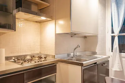 a small kitchen with a sink and a stove at Rdr Tortona Rooms in Rome