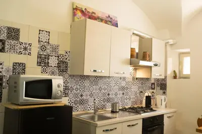 a kitchen with a sink and a microwave at I Colori di Nini Vacanza a Trastevere in Rome