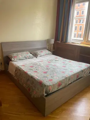a bedroom with a bed with a floral bedspread at Casa vacanze al 315 a San Giovanni in Rome