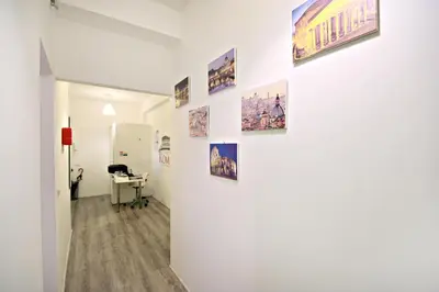 a hallway with pictures on a white wall at Le Piazze Di Roma in Rome