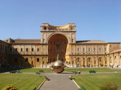 a large building with a large golden object in front of it at Le Piazze Di Roma in Rome