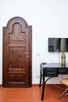 a wooden door in a room with a desk at Trastevere Charming Retreat on Cobblestone Street in Rome