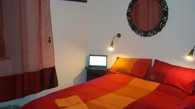 a bedroom with a bed and a mirror and a tv at Il Pretoriano in Rome