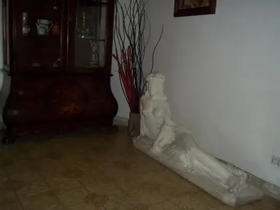 a statue of a woman leaning against a wall at Il Pretoriano in Rome