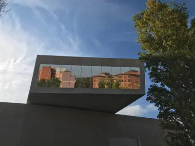 a building with a reflection of a city in the window at Maison Flaminio in Rome