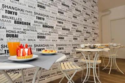 a room with a table with plates of food on a wall at Maison Flaminio in Rome