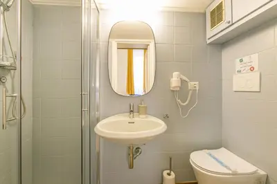 a bathroom with a sink and a toilet and a mirror at Trevi Little Palace #2 in Rome