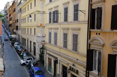 a city street with cars parked next to buildings at Trevi Little Palace #2 in Rome