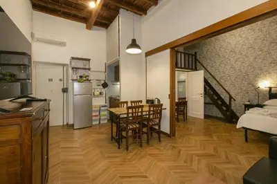 a kitchen and dining room with a table and chairs at Trevi Little Palace #2 in Rome