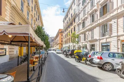 a street with cars parked on the side of the road at Cactus2023 in Rome