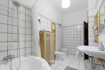 a bathroom with a tub and a sink and a toilet at Beautiful apartment with amazing Rooftop&Jacuzzi in Rome