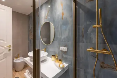 a bathroom with a shower and a sink and a mirror at RomeInSuite in Rome