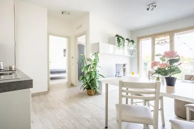 a kitchen and dining room with a table and chairs at Urban Retreat -private parking+terrace in Rome