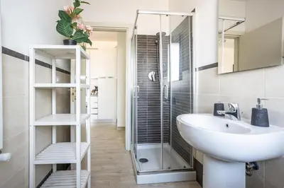 a bathroom with a sink and a shower at Urban Retreat -private parking+terrace in Rome